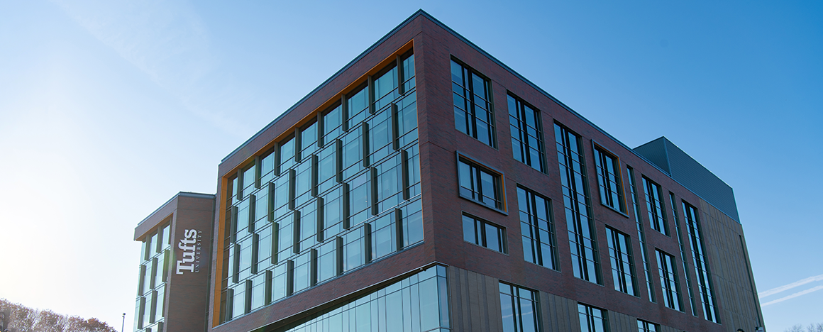 The Joyce Cummings Center against a clear blue sky