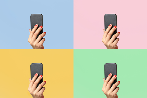 A hand holding a cell phone repeated four times with different color underlays